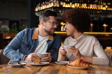 International relationships. Lovely couple having romantic date in cafe