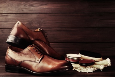 Image of Shoe care accessories and footwear on wooden background