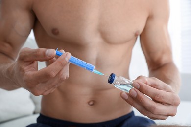 Photo of Man filling syringe with drug, closeup. Doping concept
