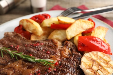 Photo of Delicious grilled beef steak and vegetables on plate, closeup