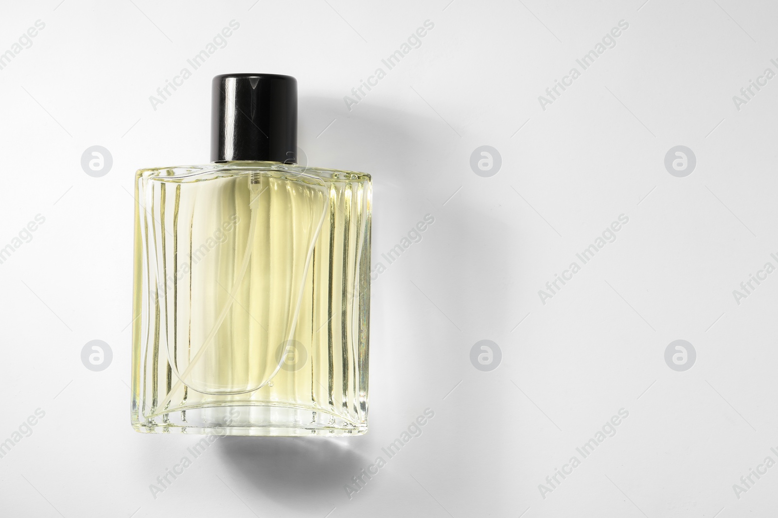 Photo of Luxury men`s perfume in bottle on white background, top view. Space for text