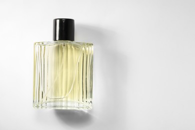 Photo of Luxury men`s perfume in bottle on white background, top view. Space for text