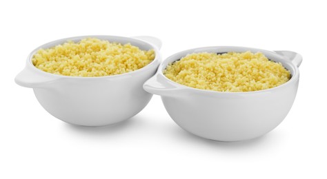 Photo of Bowls with tasty couscous on white background