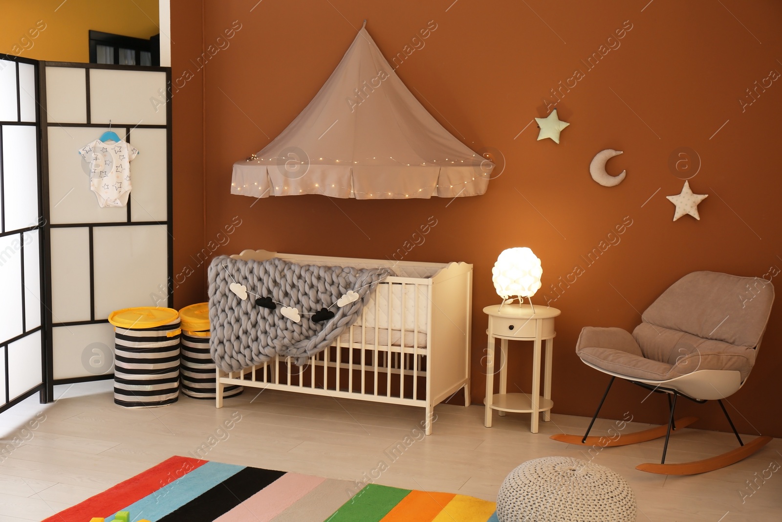 Photo of Stylish baby room interior with crib