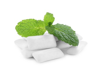 Heap of chewing gum pieces and mint on white background