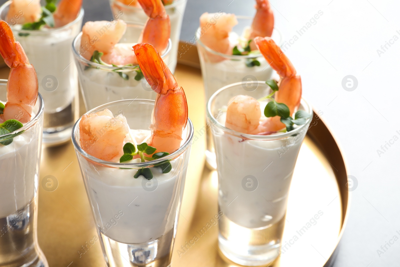 Photo of Glasses with boiled shrimps and sauce on tray