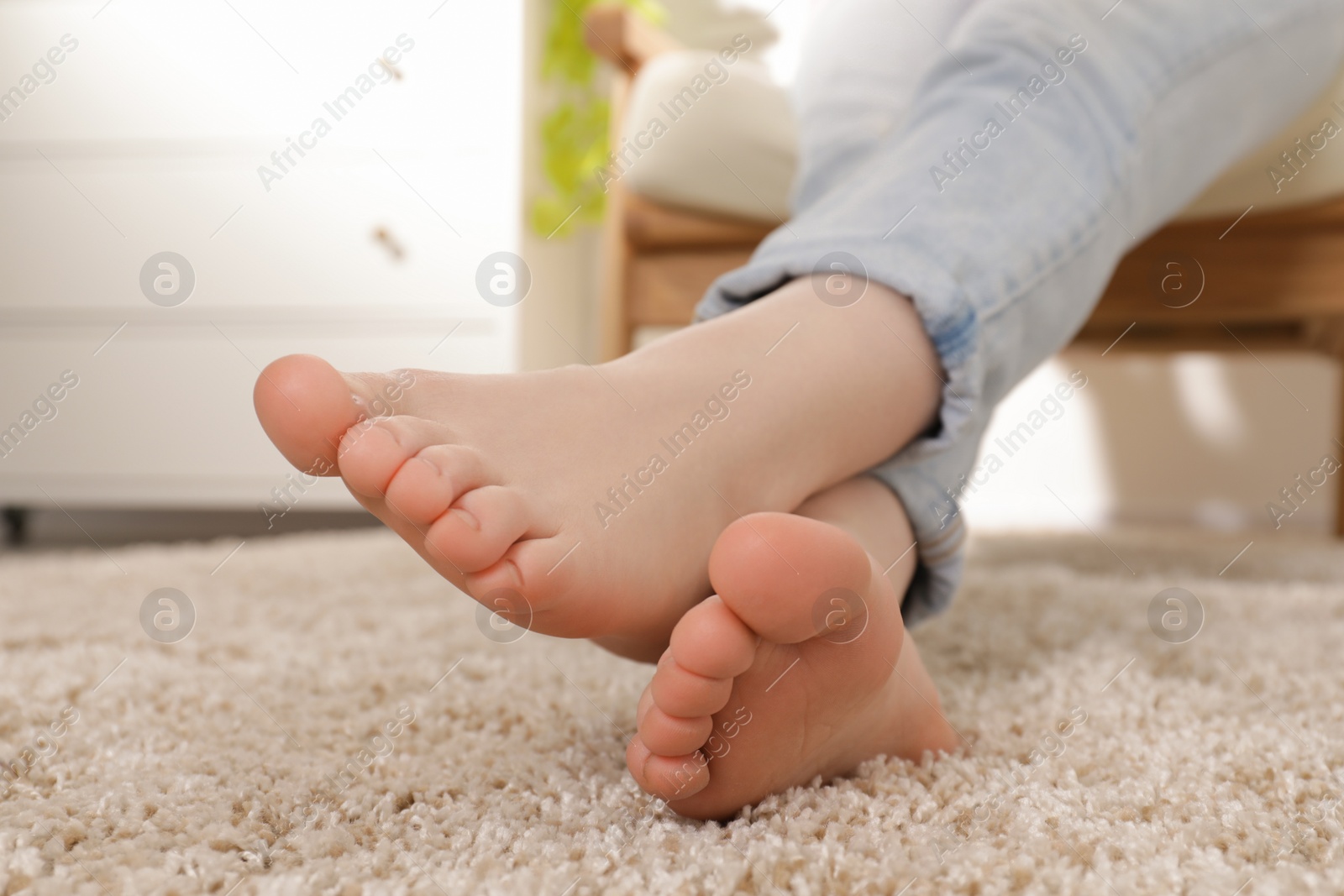 Photo of Woman sitting in armchair at home, closeup