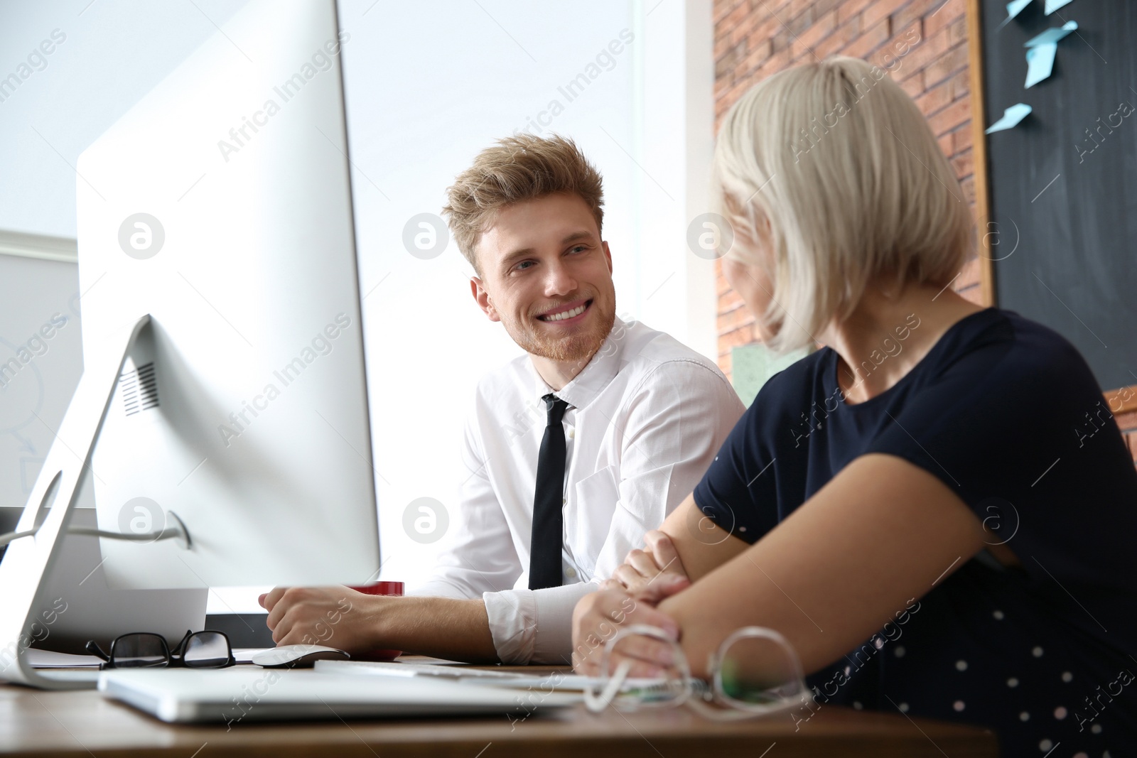 Photo of Business people working on computer at table in office. Professional communication