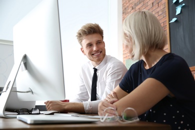 Business people working on computer at table in office. Professional communication