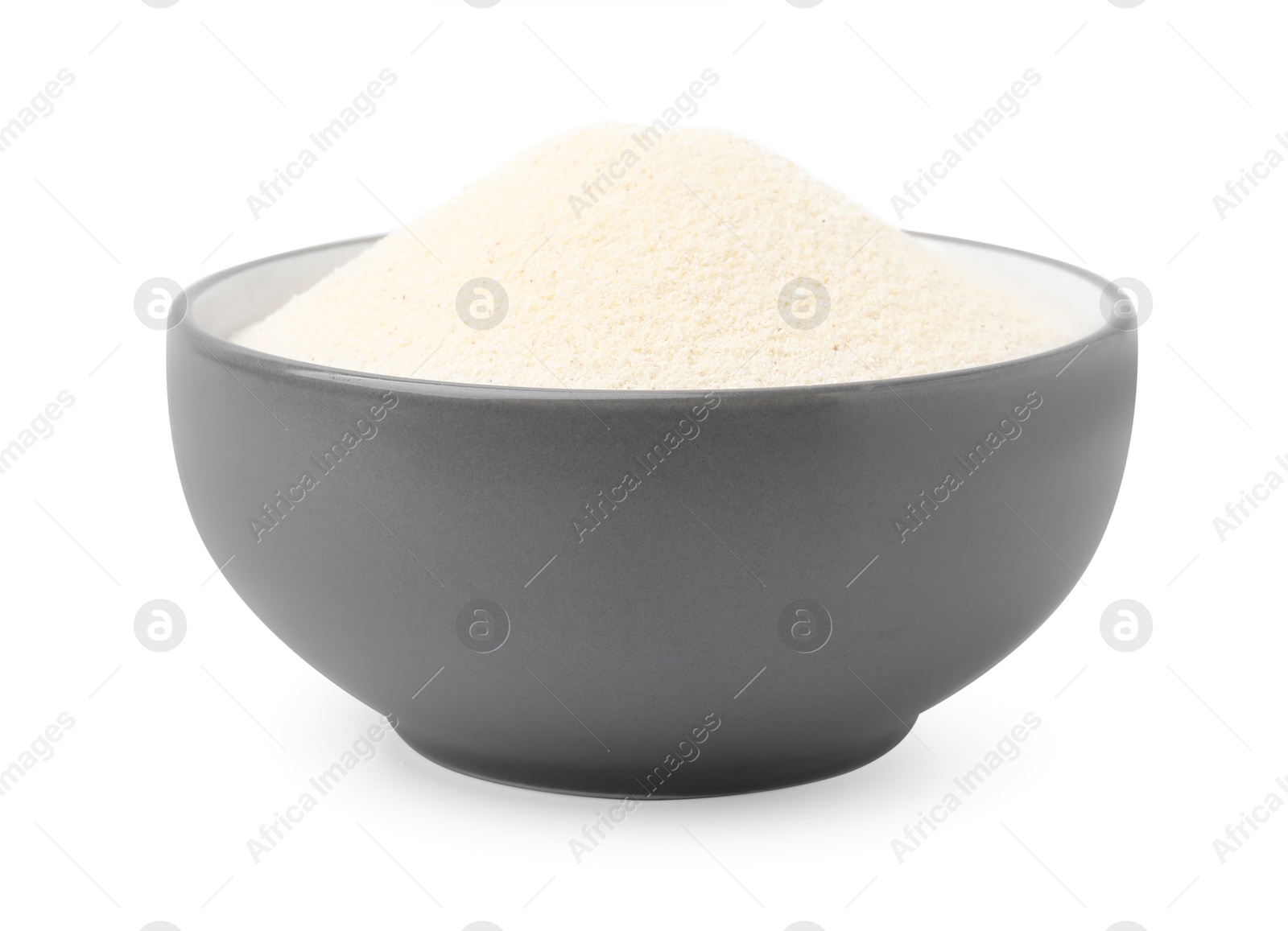 Photo of Bowl of uncooked organic semolina isolated on white