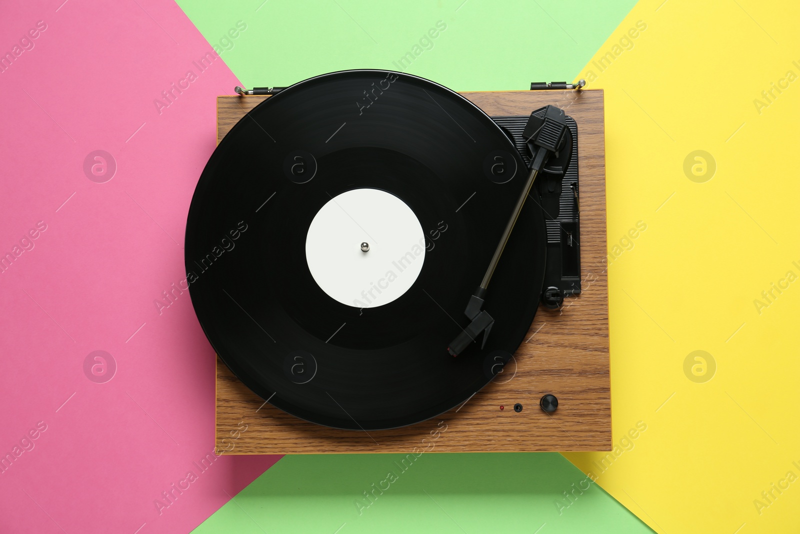 Photo of Turntable with vinyl record on color background, top view