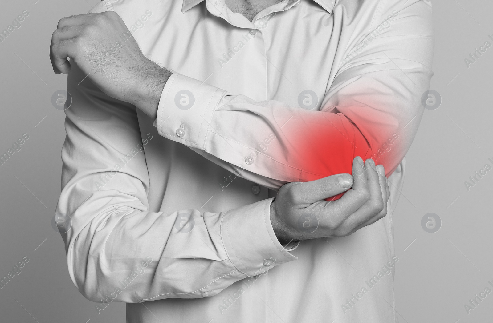 Image of Man suffering from pain in elbow, closeup. Black and white effect