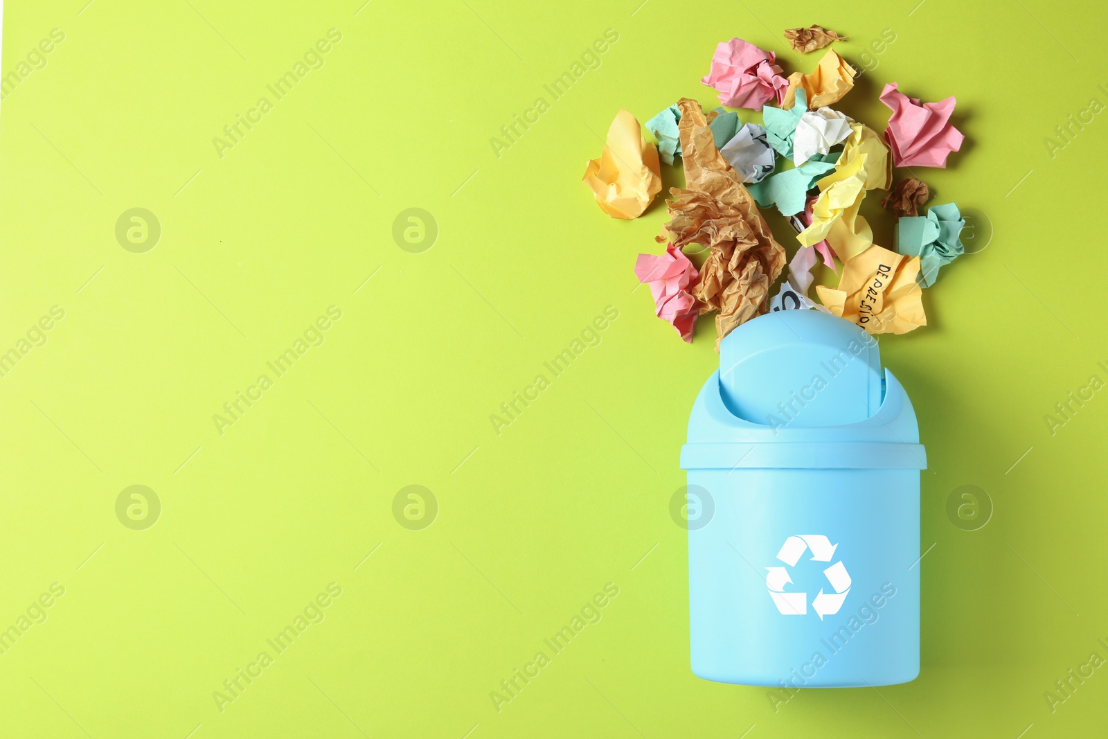 Photo of Trash bin and different garbage on color background, top view with space for text. Waste recycling concept