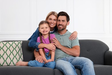 Photo of Portrait of happy family with child on sofa at home