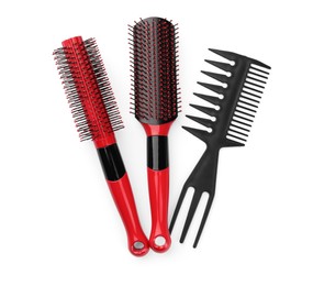 Photo of Plastic hair brushes and comb isolated on white, top view