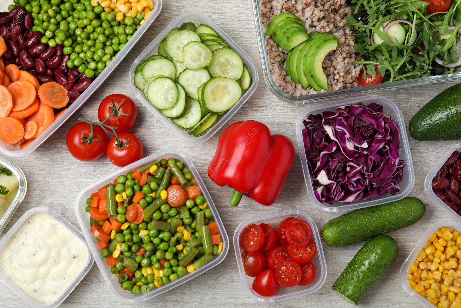 Photo of Set of containers and fresh food on white wooden table, flat lay