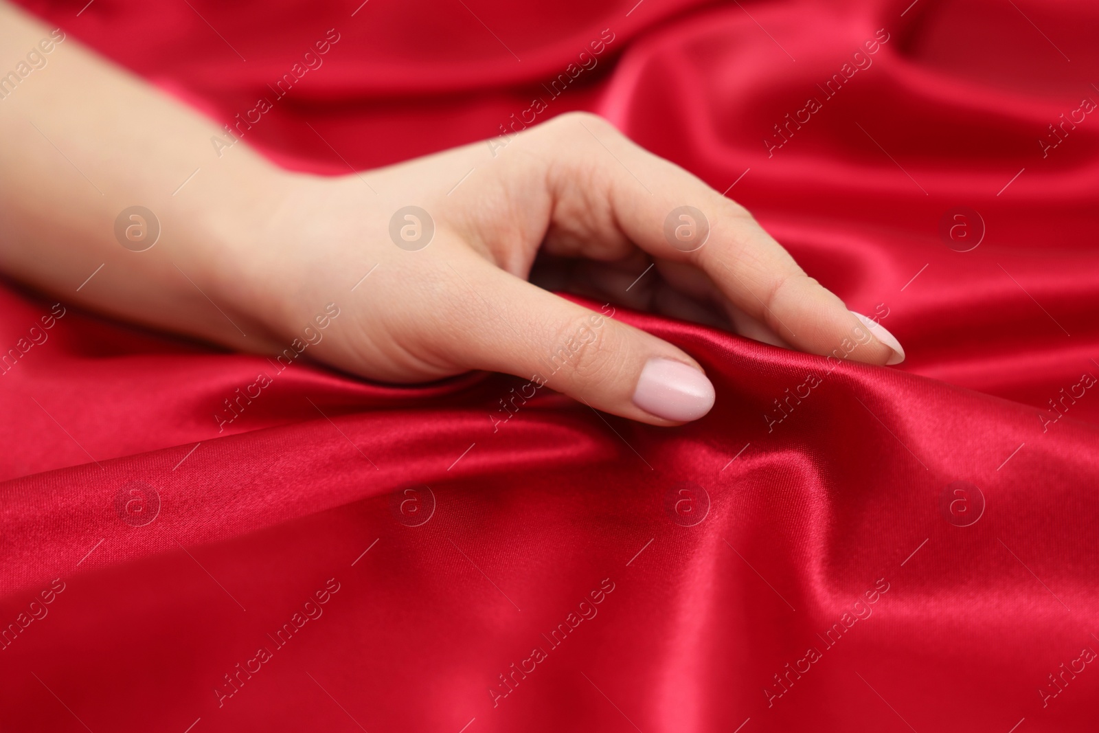 Photo of Woman touching smooth silky fabric, closeup view