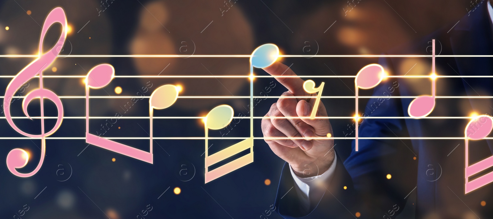 Image of Musician pointing at staff with music notes and symbols on color background, closeup. Banner design
