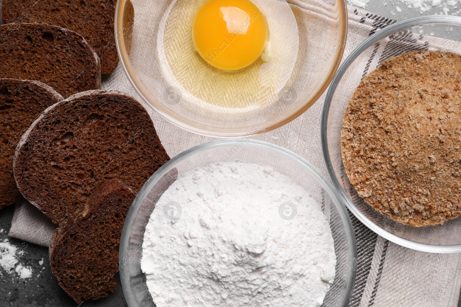 Photo of Fresh breadcrumbs, flour and egg on table, flat lay