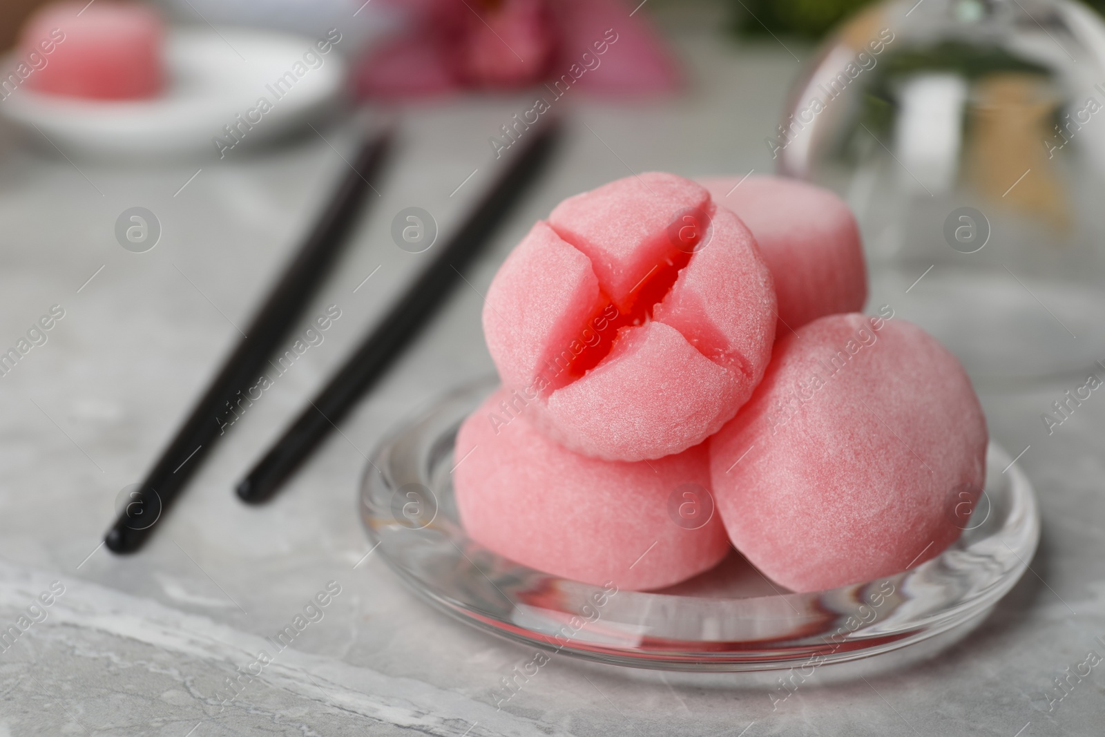 Photo of Delicious mochi on grey table, space for text. Traditional Japanese dessert