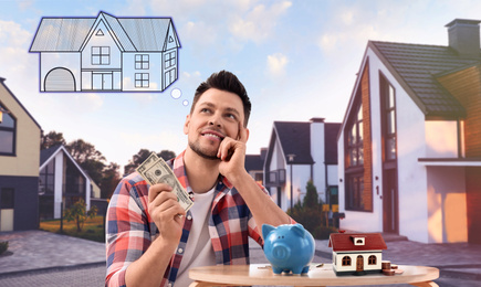 Image of Man with money and piggy bank daydreaming about house