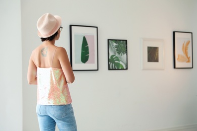 Young woman at exhibition in art gallery