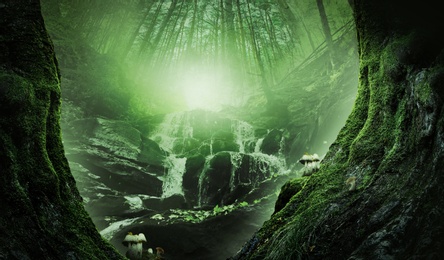 Image of Fantasy world. Waterfall in heart of enchanted misty forest