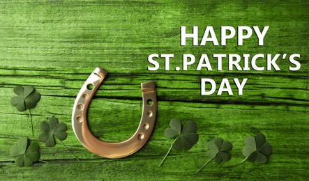 Image of Happy St. Patrick's Day. Clover leaves and horseshoe on green wooden table, flat lay 
