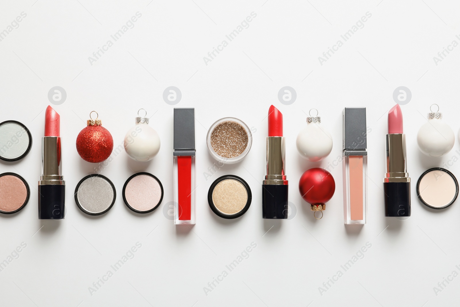 Photo of Flat lay composition with makeup products and Christmas decor on white background