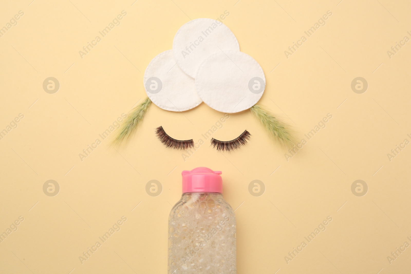 Photo of Flat lay composition with makeup remover, spikelets and false eyelashes on yellow background