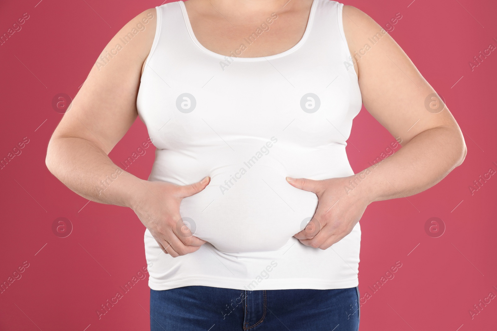 Photo of Overweight woman on color background, closeup. Obesity and weight loss