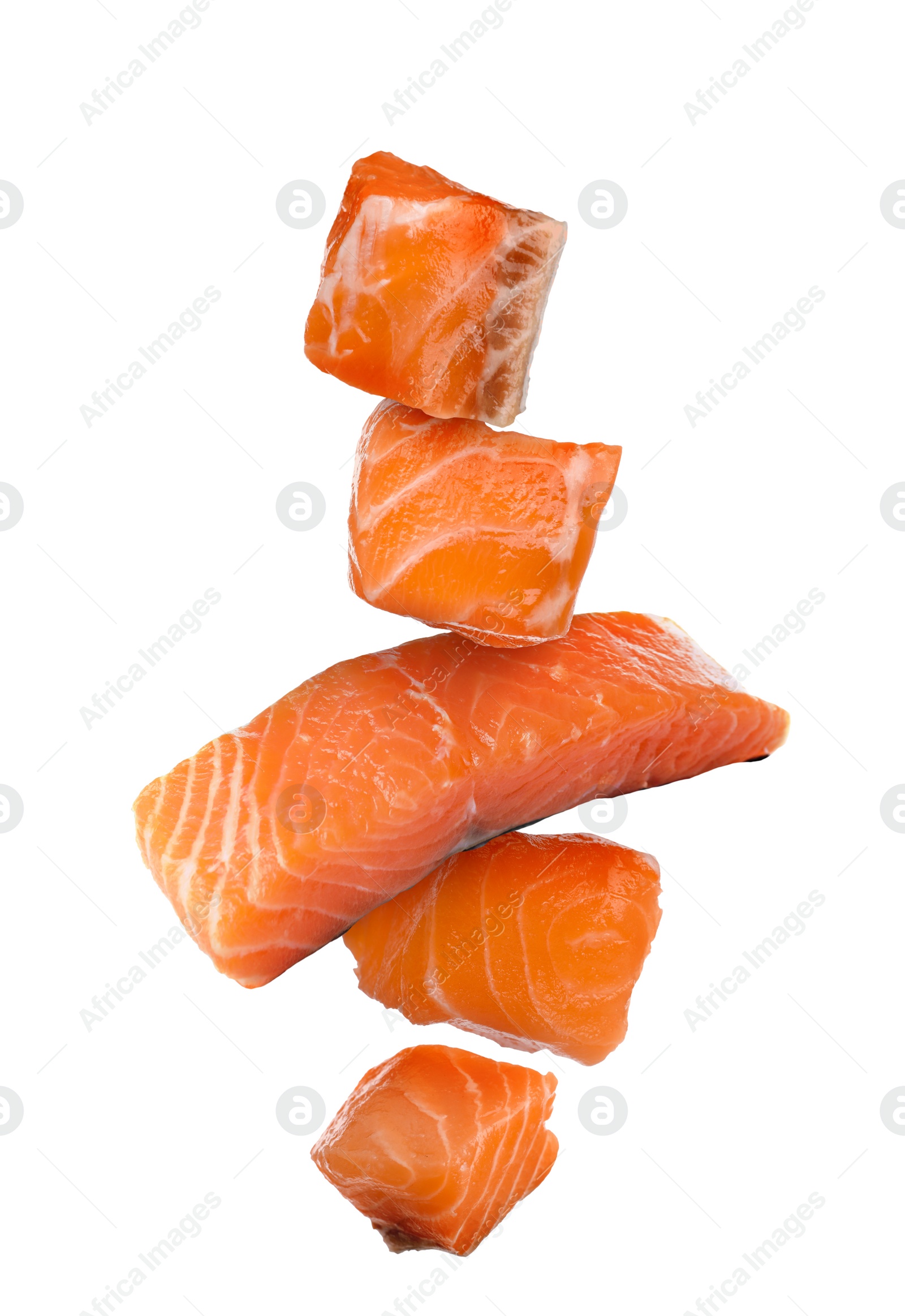 Image of Cut fresh salmon falling on white background