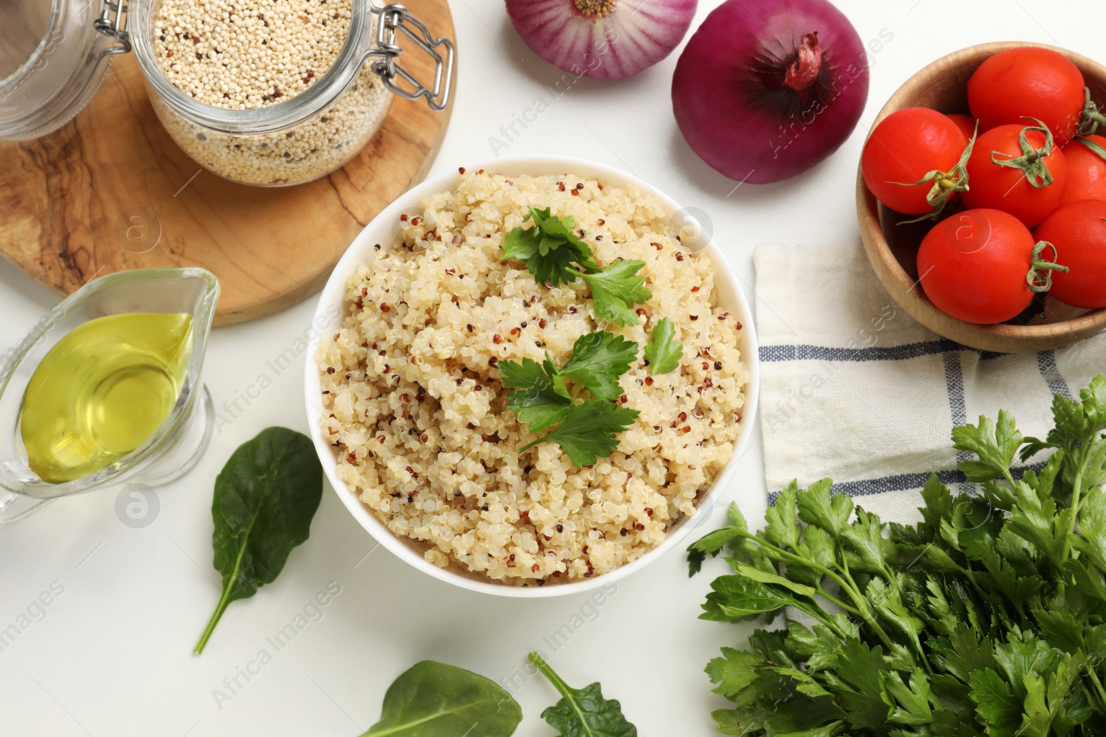 Photo of Flat lay composition with bowl of tasty quinoa porridge and vegetables on white table