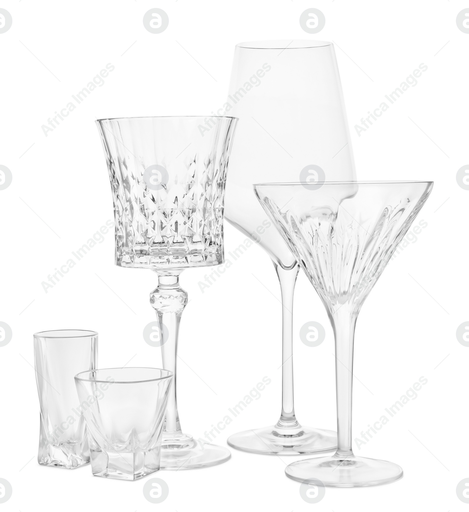 Photo of Different elegant empty glasses isolated on white