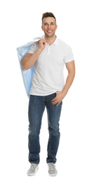 Man holding hanger with shirt in plastic bag on white background. Dry-cleaning service