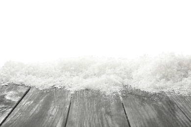 Photo of Snow on grey wooden surface against white background. Christmas season