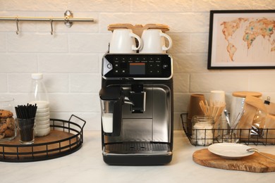 Photo of Modern coffee machine on countertop in office kitchen
