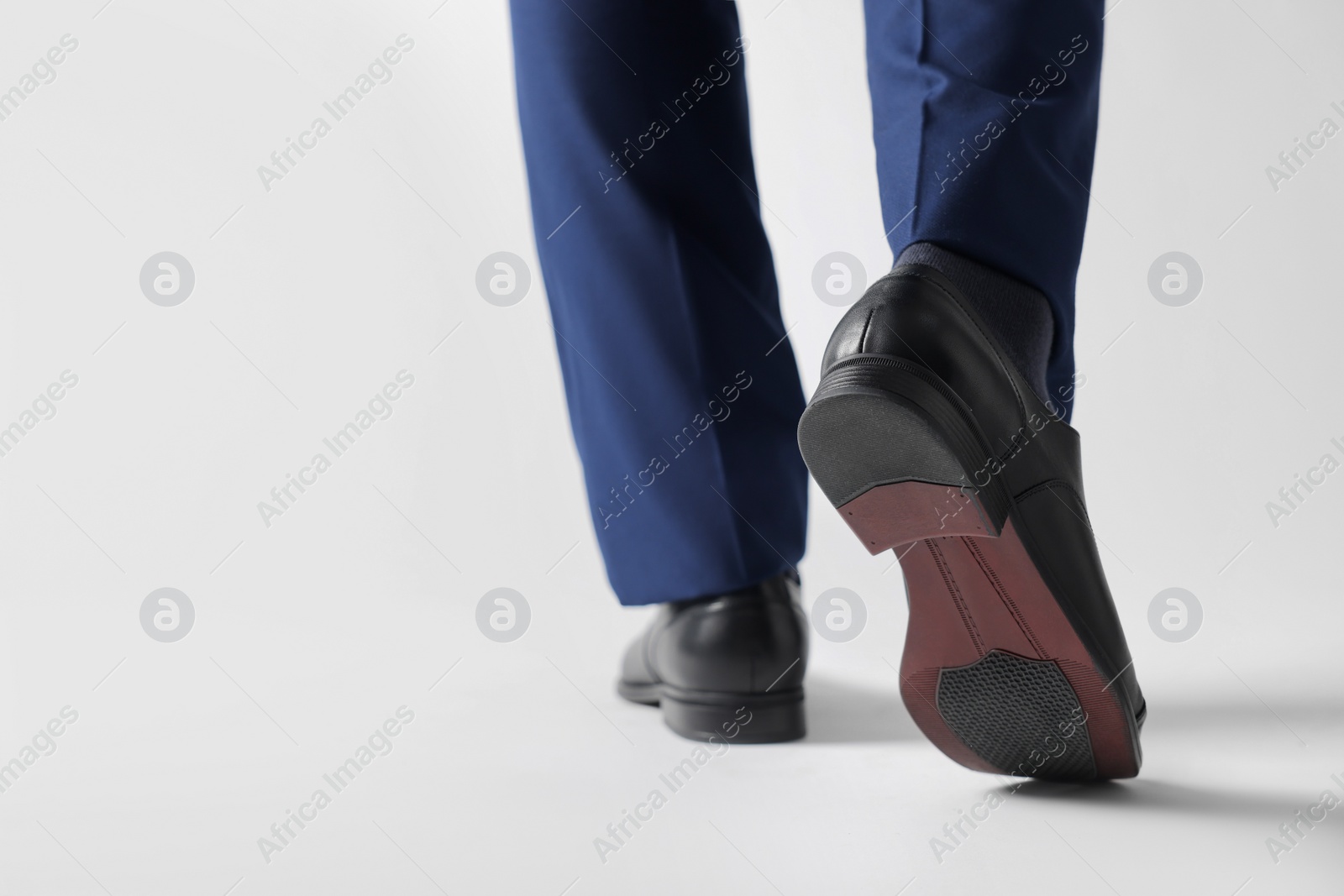 Photo of Businessman in leather shoes on white background, closeup