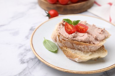 Photo of Delicious liverwurst sandwich with tomatoes and basil on white marble table