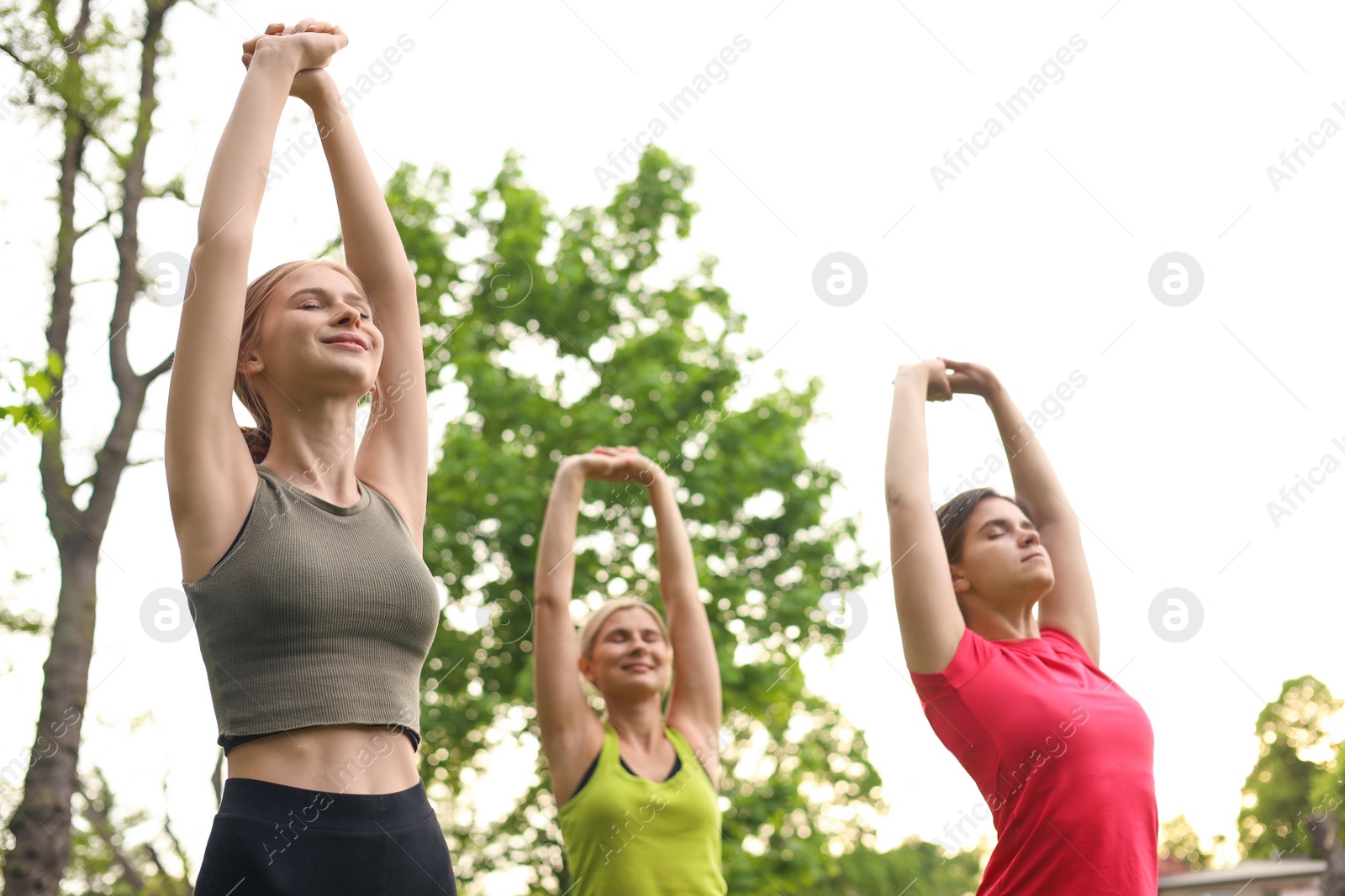 Photo of Women and teenage girl doing morning exercise in park