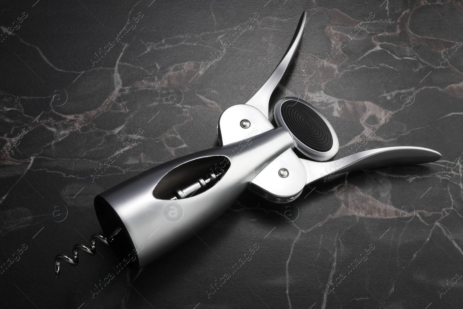 Photo of One wing corkscrew on black marble table