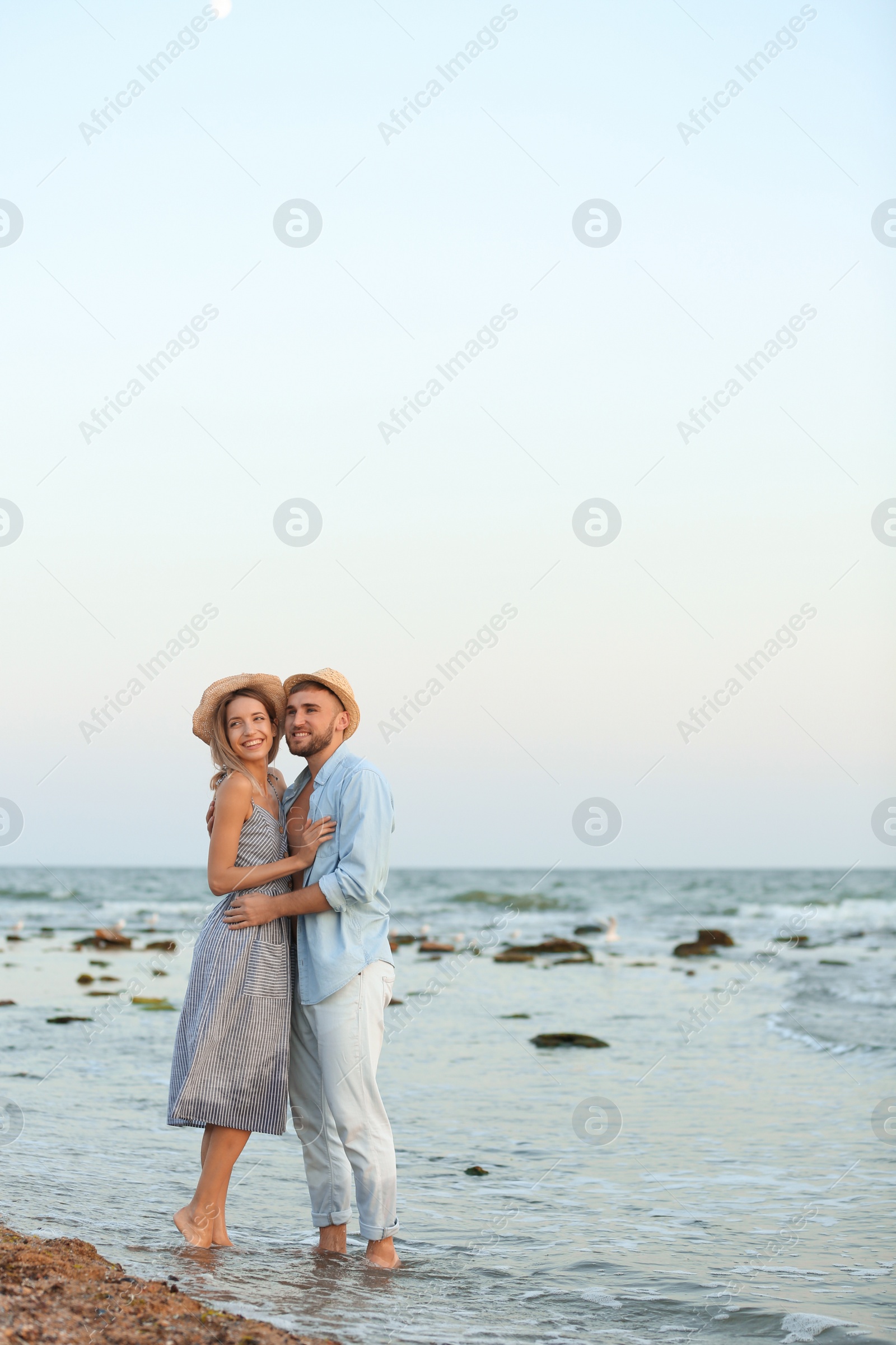 Photo of Young couple spending time together on beach