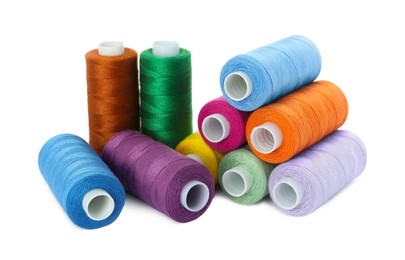 Photo of Set of different colorful sewing threads on white background