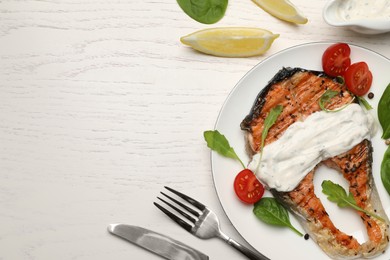 Tasty salmon steak served on white wooden table, flat lay. Space for text