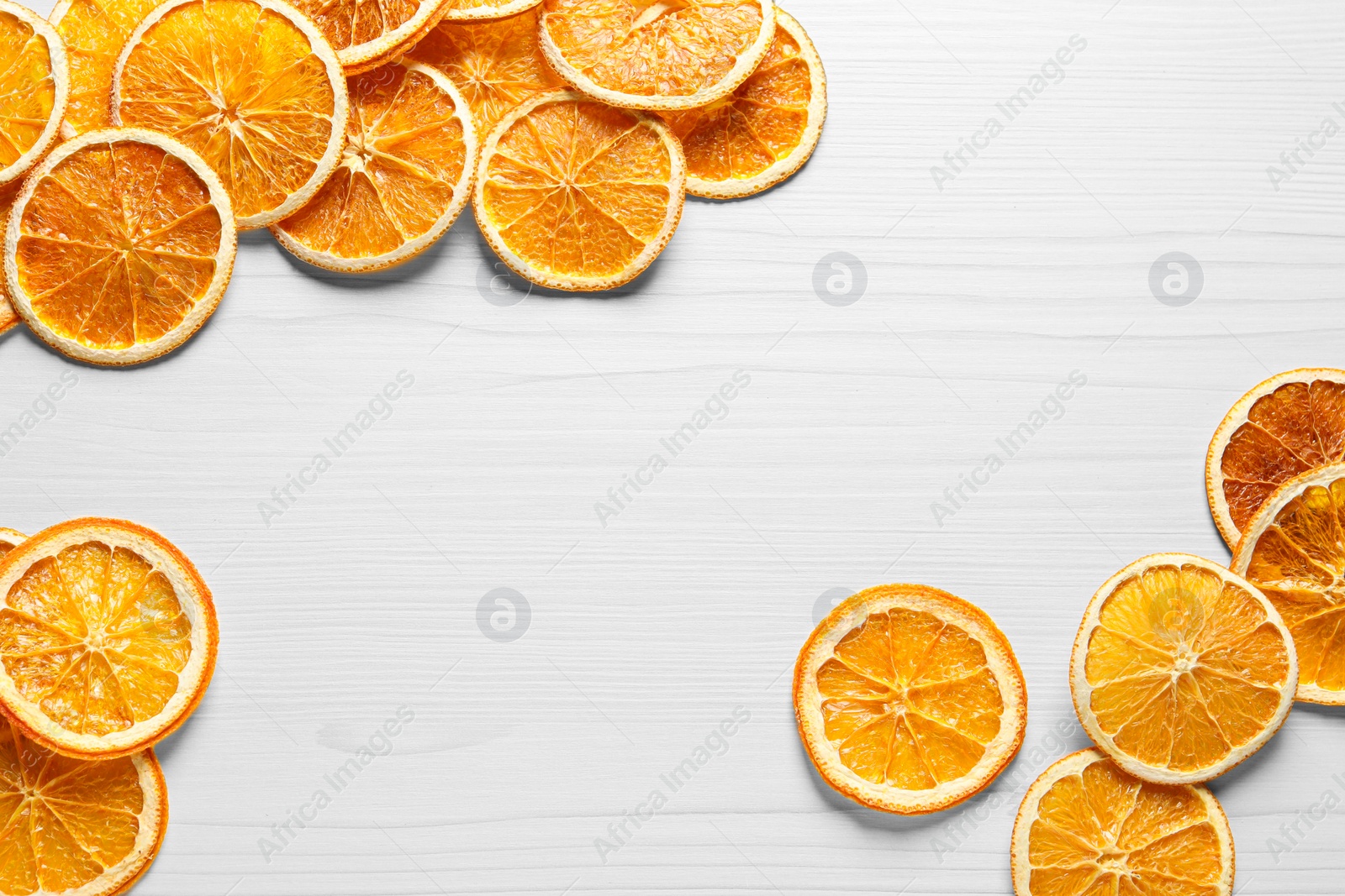 Photo of Many dry orange slices on white wooden table, flat lay. Space for text