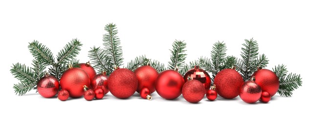 Red Christmas balls and fir twigs isolated on white