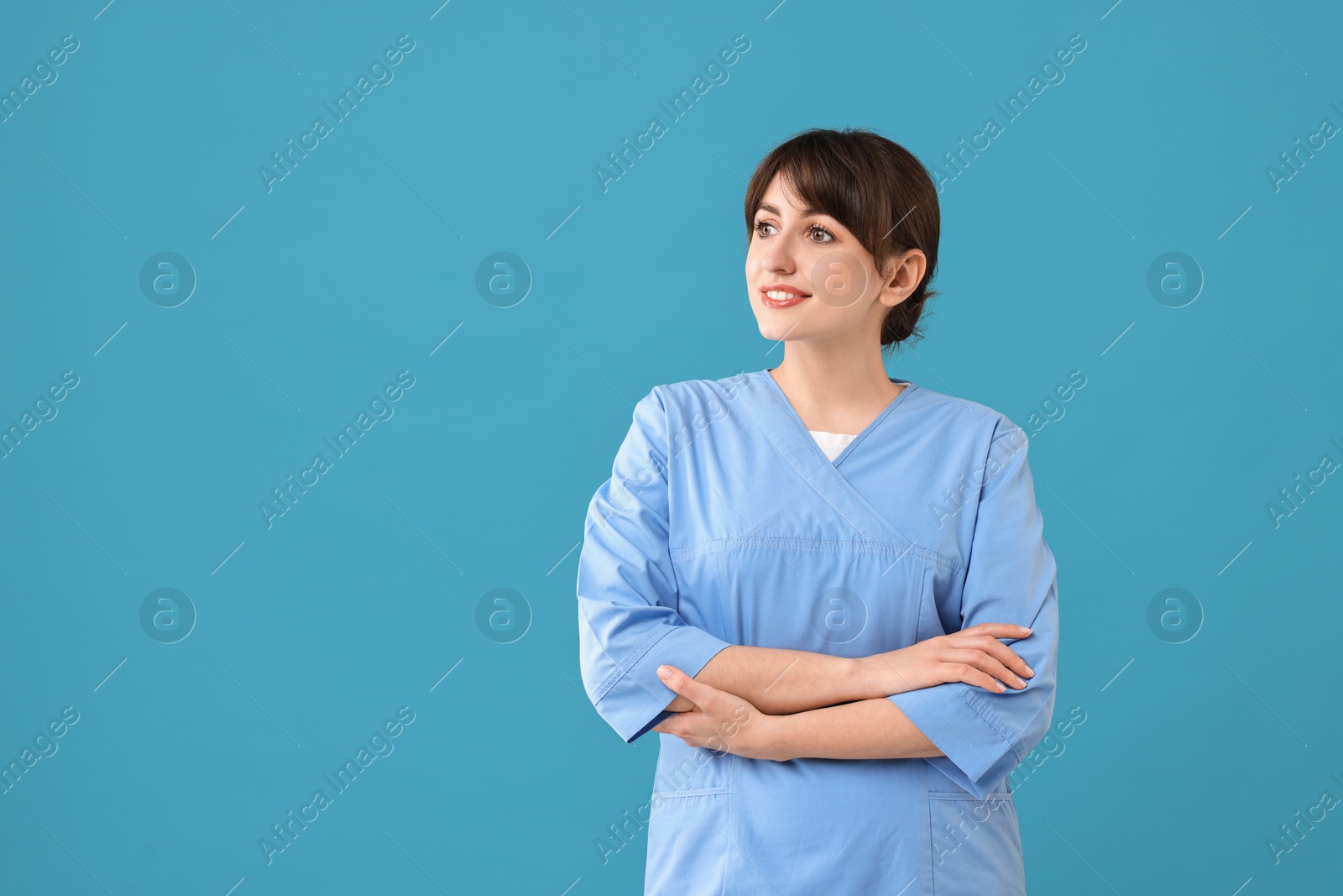 Photo of Portrait of smiling medical assistant on light blue background. Space for text