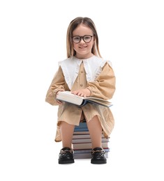 Photo of Cute little girl in glasses with many books on white background