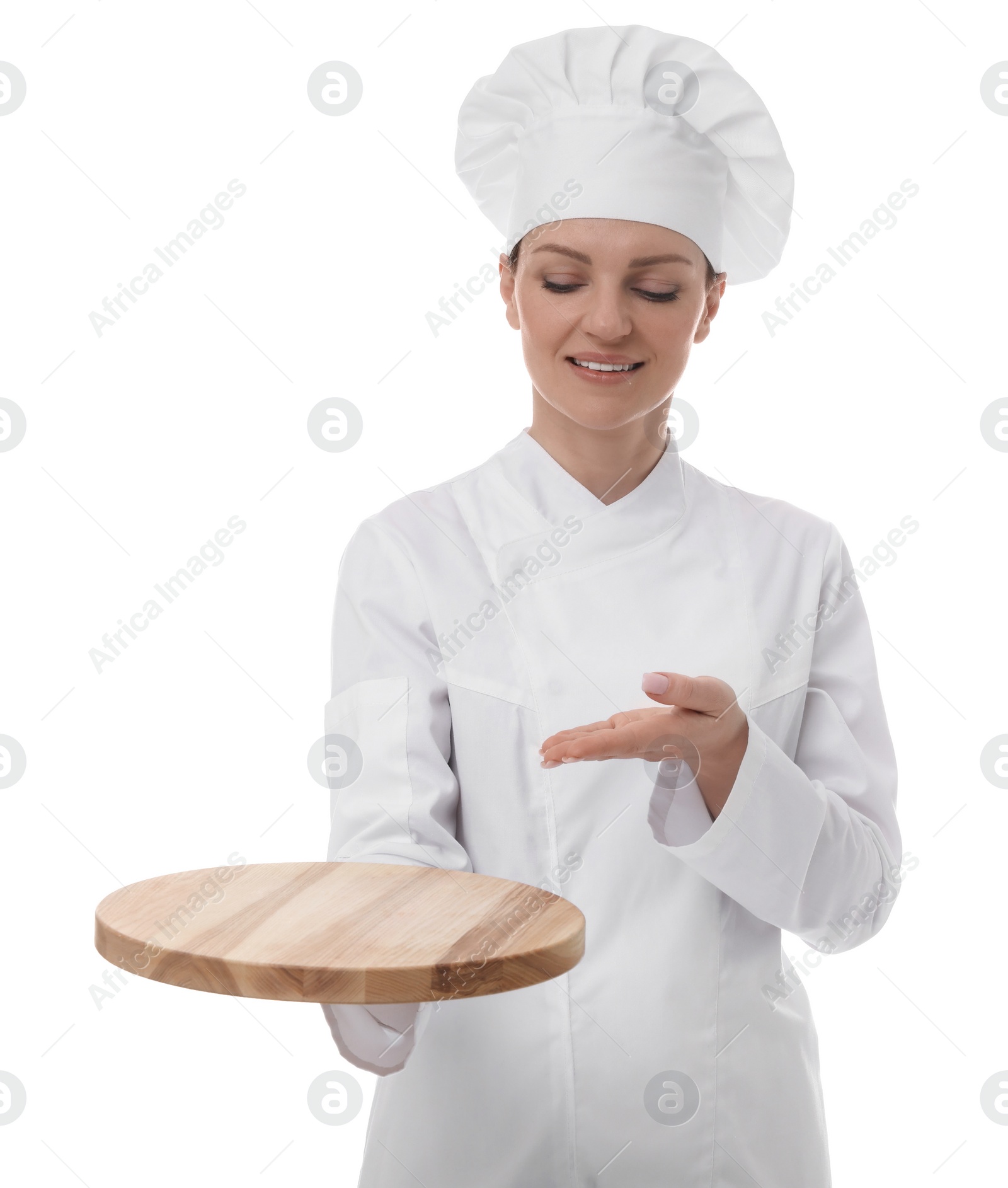 Photo of Happy chef in uniform holding empty wooden board on white background