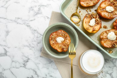 Tasty baked quinces with nuts and cream cheese served on white marble table, flat lay. Space for text